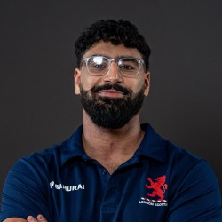 Ali smiles at the camera, wearing London Scottish RFC kit.