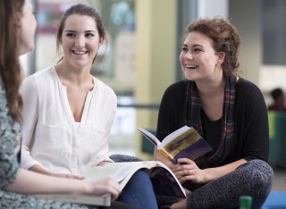 Students talking and holding books