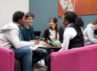 A diverse group of students sitting in a coffee shop