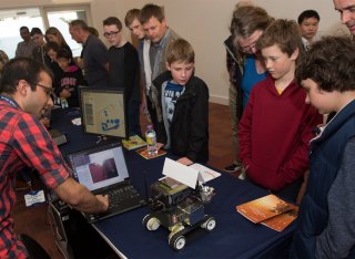 Man showing kids a robot