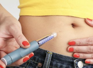 Lady injecting herself with diabetes medication