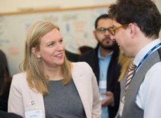 A man and woman talking at a business event