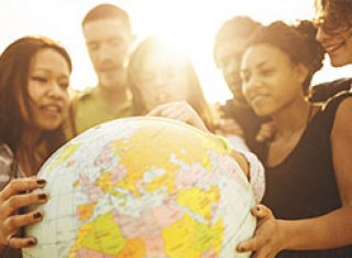 A group of people gathered around a globe