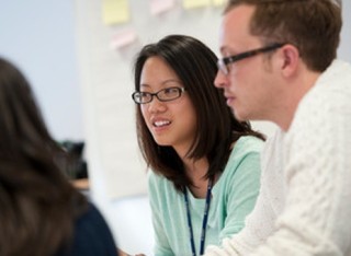 Three PhD students participating in a workshop