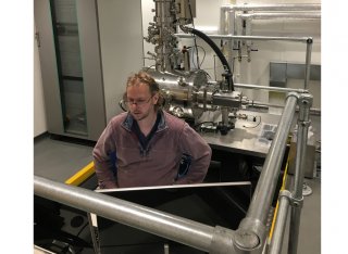 David Cox, a focussed ion beam expert from the University of Surrey and the National Physical Laboratory performing commissioning tests at the console of the new SIMPLE tool in its new laboratory at Surrey.