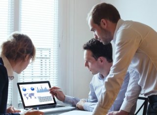 People looking at a laptop