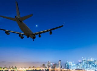 Aeroplane landing over city