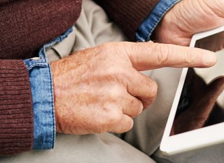 Elderly man using a tablet