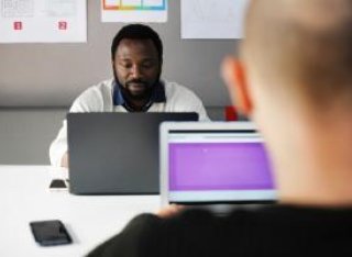 Two males on laptops