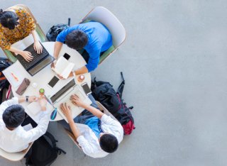 Birdseye view of students sitting around table