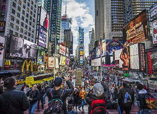A busy scene showing tourists walking round New York 