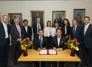 University of Surrey team including Max Lu celebrate UCF funding sat round a table