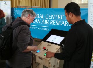 Two men using machine at GCARE event