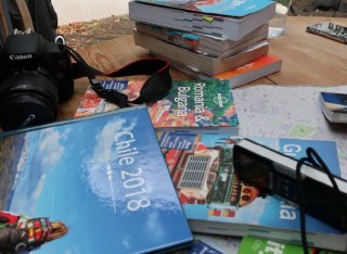 Books and camera on table