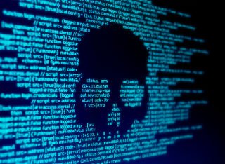 Transnational cybercrime is depicted through a skull on a computer screen