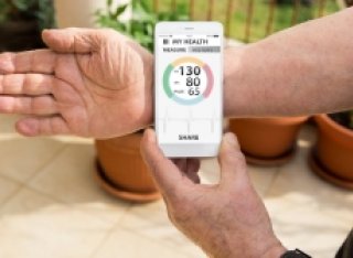 Person checking their heartbeat with tracker device