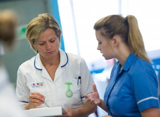 Two nurses working together having a discussion