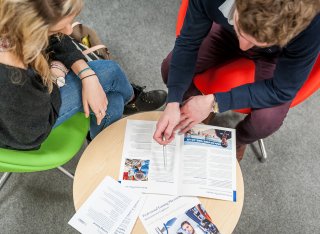 Careers adviser and student sitting at a table.