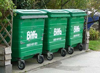 A row of three green bins