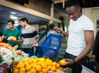 Students buying vegetables at the University of Surrey Fruit and Veg Market