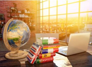 Globe and language dictionaries on a desk