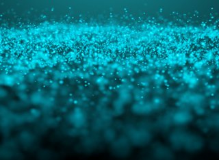 A glowing teal glitter cloud on a dark empty background 