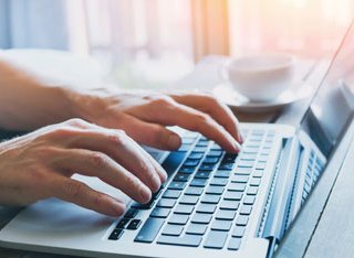 Person typing on a keyboard