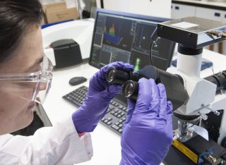 Female using a microscope