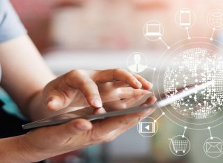 Woman using mobile with icons circling a globe