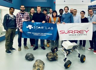 The Star Lab team holding up STAR Lab and Surrey Space Centre posters