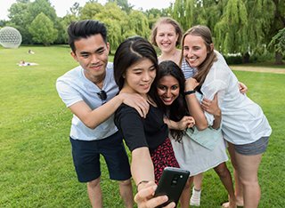 A group of students taking a selfie on the Surrey campus.