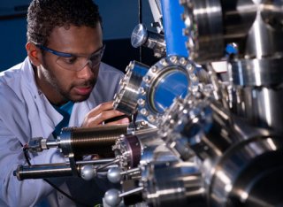 Student using mechanical engineering equipment