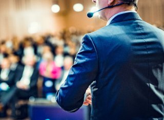 Person speaking to a crowd