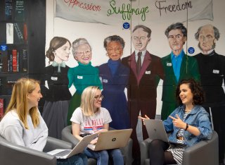 Three female student sat talking