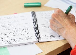 Person writing in notebook