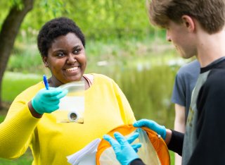 Student holding sample in a bag, collected from a lake