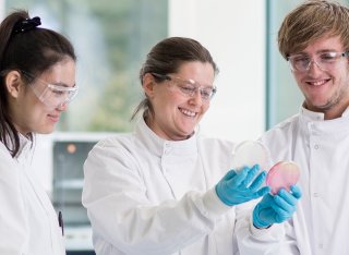 Dr Alison Cottell showing students petri dish