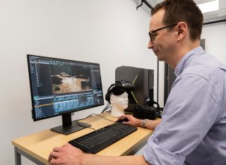 A man is observing brain action through imaging technology.