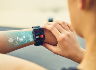 Woman using a watch with heart monitor app
