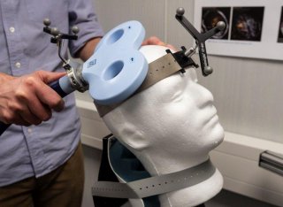 Person using equipment to monitor brain behaviour
