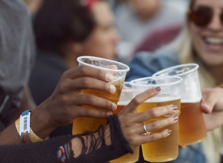 Students cheering with beers in plastic cups