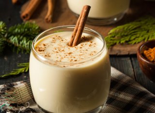 Glass of eggnog with a cinnamon stick in
