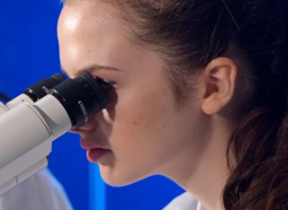 Student looking through a microscope