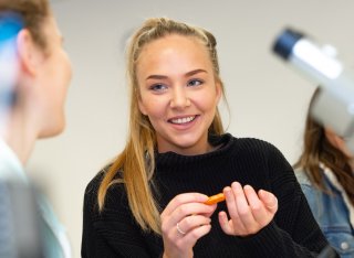 Student pricking her finger to test her blood sugar levels