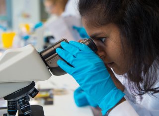 Student looking through a microscope