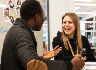 Two students talking in the Library