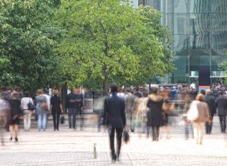 Crowd of people walking in city