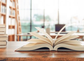 Open book on table in a library