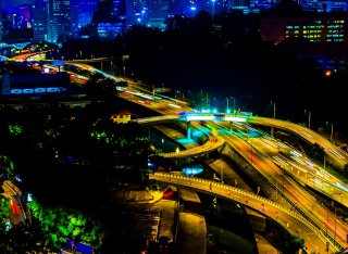 Busy intersection at night in Kuala Lumpur