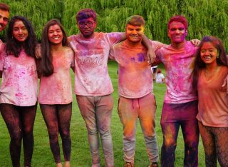 Group of students cover in colourful paint
